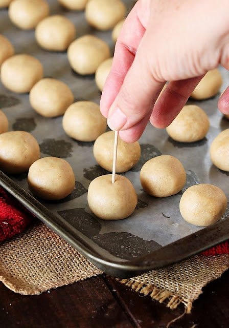  sweetened peanut butter centers peeking through a chocolate Peanut Butter Buckeyes Recipe: Step-by-Step