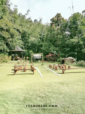 A garden with wedding decorations, dream catchers and wooden benches in Harmony Valley Retreat Janda Baik, Pahang Malaysia