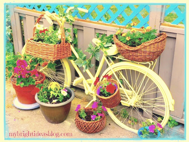 vintage yellow bike garden planter baskets flowers