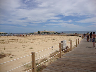 People in Salgados Beach wooden footbridge photo - Algarve