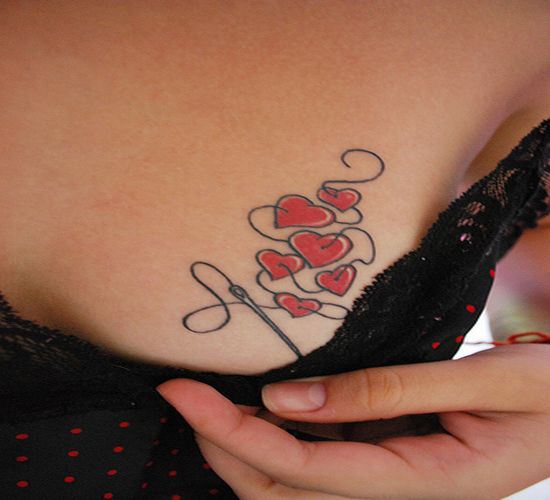 Little needled hearts tattoo on the breast looks simply awesome,