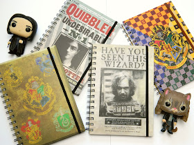 A photo of four Harry Potter themed notebooks 