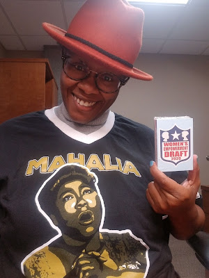 Dr. Malika Carter modeling Mahalia Jersey and holding a deck of 2020 Women's Empowerment Cards