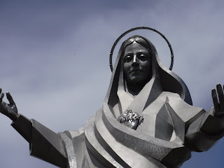 a statue of Mary with outstretched arms at Trinity Heights in Sioux City