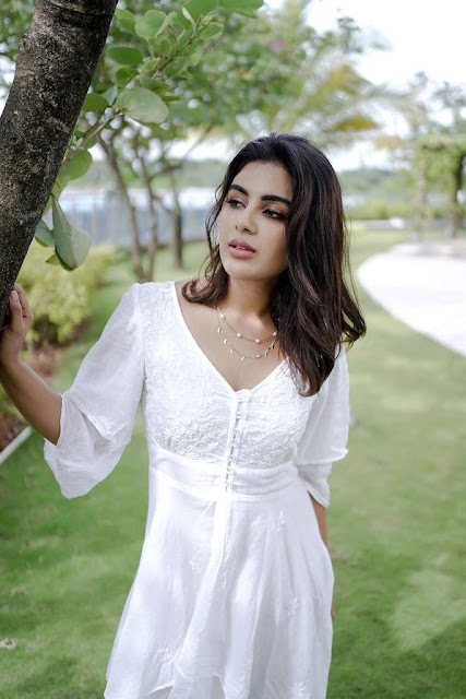 Samyuktha Menon shines in a white dress, showcasing her timeless beauty and elegant charm in the latest breathtaking photos.