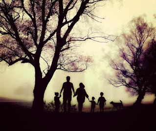 silhouette of family walking