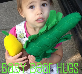 child with toy lulav and etrog for sukkot