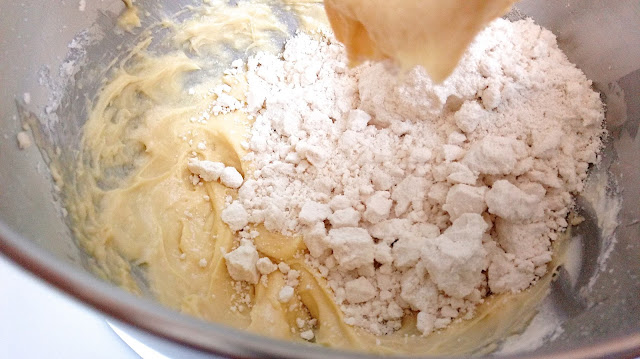 cake mix batter in process in the stainless steel bowl of a stand mixer
