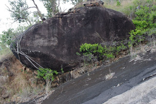 Giant boulder resting on steep slope