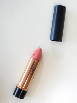 A close up shot of the open Lush refillable lipstick, showing the nude pink coloured shade Liverpool.