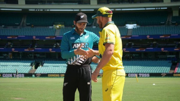 Williamson & Finch at toss in front crowd.