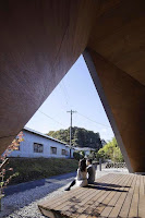 Origami House Design with A-Frame in an Old Village Surrounded by Mountains