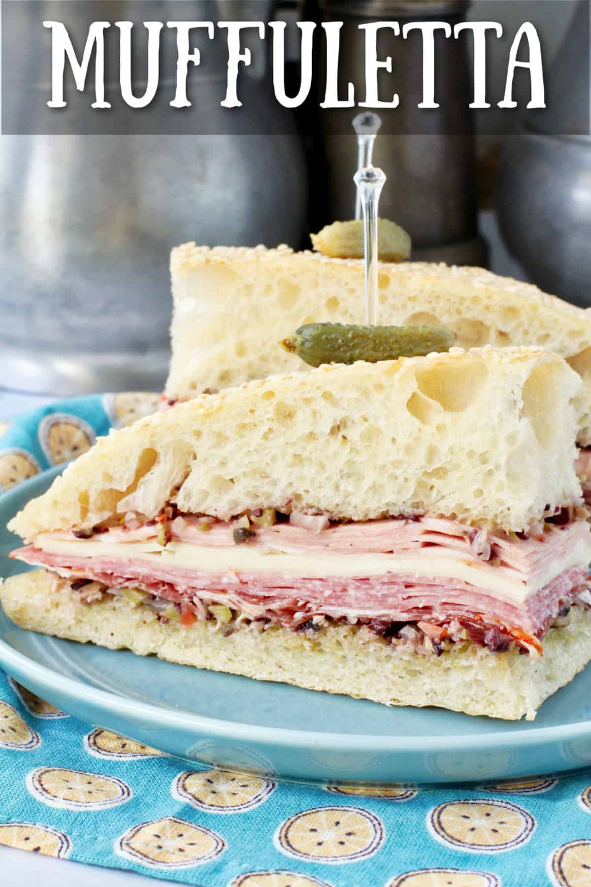 Muffuletta Sandwich with Homemade Bread on a blue plate.