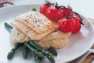 Salmon with garlic bean puree, asparagus and tomatoes