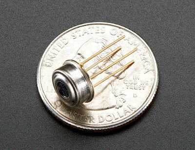 Melexis MLX90614 infrared temperature sensor on top of a quarter for scale