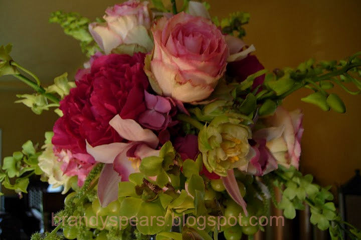 tall wedding flowers centerpiece in pink and green with hanging grapes