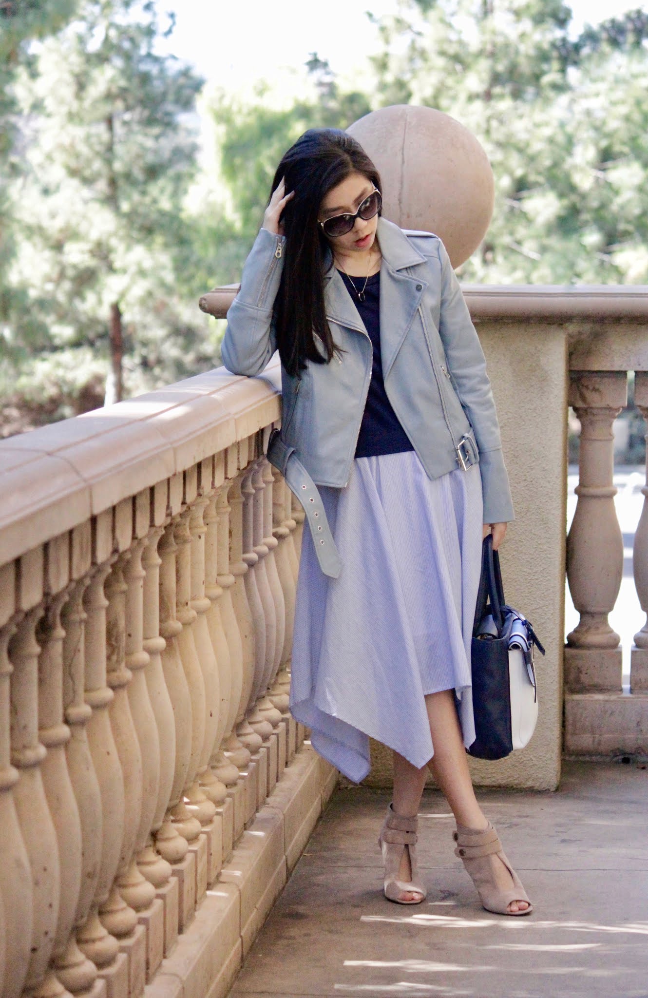 what to wear with a baby blue leather zipper motorcycle jacket - how to wear a motorcycle jacket with an asymmetrical midi dress-adrienne nguyen