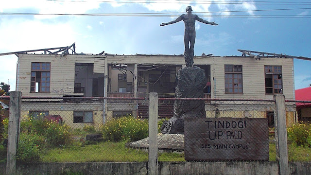 The UP Oblation monument with a Yolanda devastated building of UP-SHS in the background, Palo Leyte