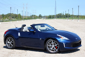 Blue 2013 Nissan Z Roadster sideways in parking lot