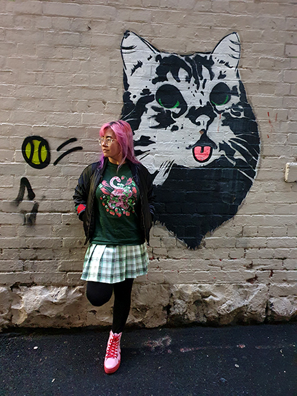 Marta Tesoro wearing a long sleeve top from TeePublic with her Strawberry Skull top in the urban streets of Melbourne