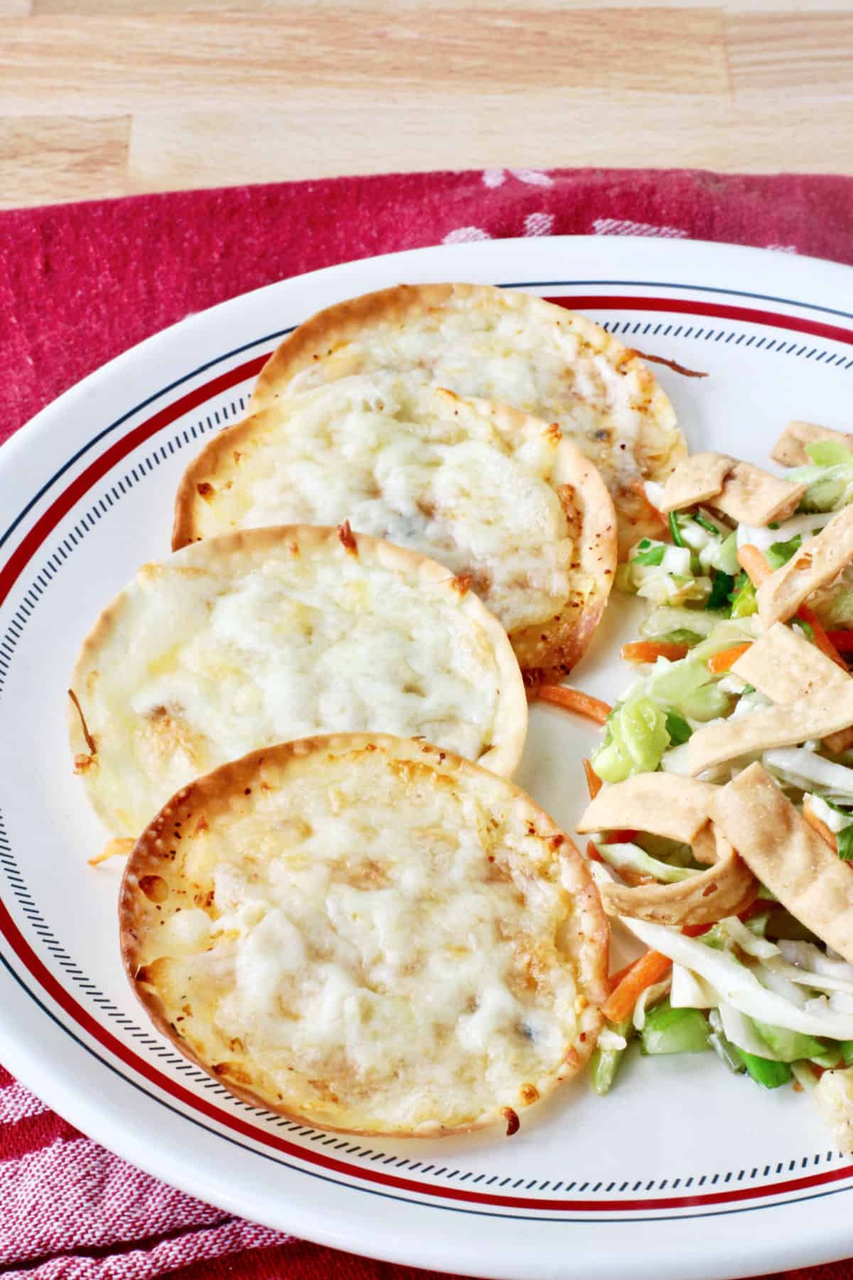 Gyoza Wrapper Pizza Bites on a white dinner plate for serving.