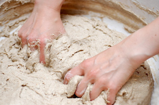Hands mixing dough