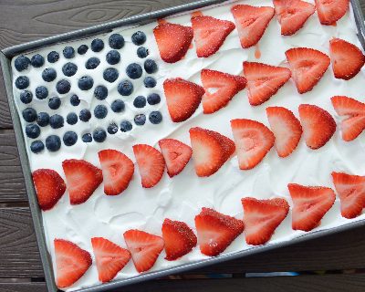 American Flag Cake with Strawberries & Blueberries ♥ KitchenParade.com, use fresh berries to decorate a poke cake with the American flag.