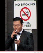 The 'Gangnam' singer, Psy lighting up right next to a 'No smoking sign. (psy)