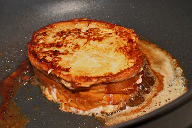 Italian Style French toast in a griddle pan with butter frying