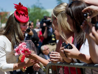 Kate, Duchess of Cambridge, is guarded by security as she greets royal fans after visiting the Museum of Civilization in Gatineau, Canada on Friday, July 1, 2011.