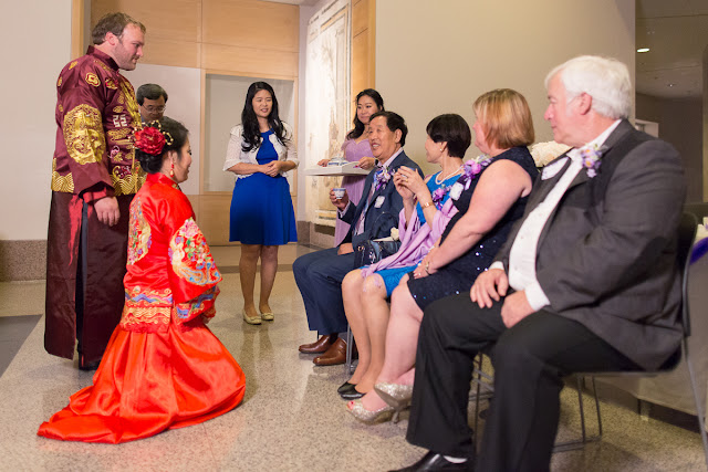 In Chinese tradition, it is customary for the newly wedded couple to dress in traditional robes and host a Tea Ceremony for their parents.  Beginning with the bride, she offers a warm cup of tea to her mom, then father, and then her husband does the same.  In return, a red envelope and gift is handed to them.  Then it is the groom's parent's turn.  He goes first, and then she does, serving tea to each parent.  And receiving a gift in return.  Taken at the Sam Noble Oklahoma Museum of Natural History in Norman, OK.