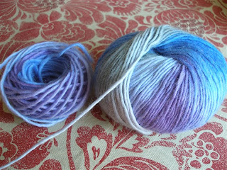grey, purple, and blue yarn ball