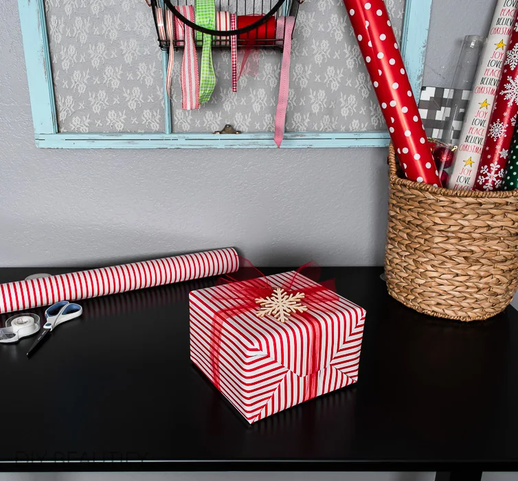 red striped gift with wood snowflake