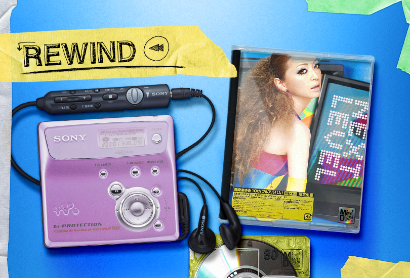 A pink Sony MiniDisc player sat alongside a MiniDisc copy of Ayumi Hamasaki’s album, ‘Next Level’. On the top left is a strip of yellow masking tape with the word ‘Rewind’ on it.