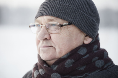 Elderly man wearing a winter hat and coat