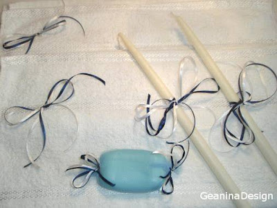 Lumanari pentru preot, prosoape si sapun pentru botez impodobite cu fundite bleumarin si albe in acord cu culorile celorlalte accesorii ale botezului.