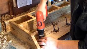 Screwing the coat hooks to backboard 