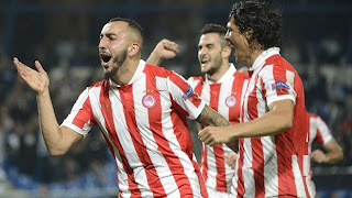 Kostas Mitroglou celebrates his winning goal with François Modesto and Charalambos Lykogiannis.