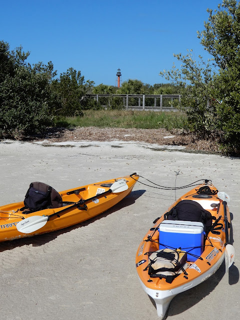 lighthouse and kayaks