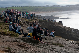 Crowded beaches in Cornwall watch big wave surfing