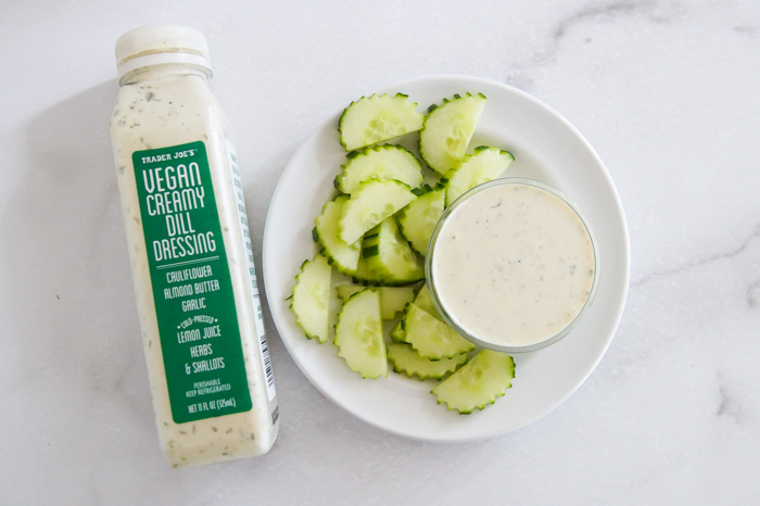 Trader Joe's Vegan Creamy Dill Dressing, bottle, in bowl, and plate of cucumbers