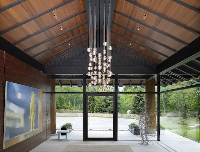 Hallway of Aspen Residence by Stonefox with glass walls and painting on the wall