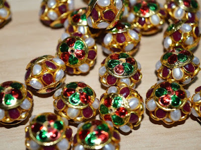 http://www.indianlacesandfabric.com/Beads-Buttons/bea112-5-Meenakari-pachi-bead-with-gemstones