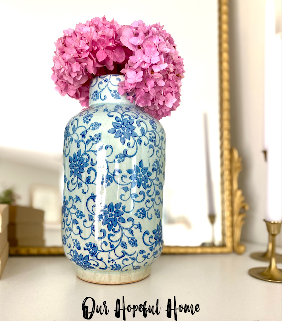vintage looking blue and white floral vase with pink hydrangeas