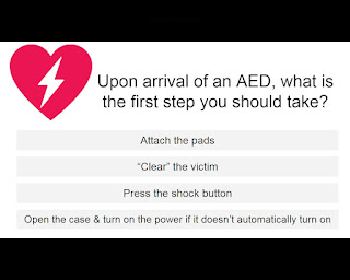 Upon arrival of an AED, what is the first step you should take? Answer choices include: Attach the pads, "Clear" the victim, Press the shock button, Open the case & turn on the power if it doesn't automatically turn on