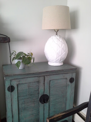 green asian style cabinet pier1 pineapple lamp plants