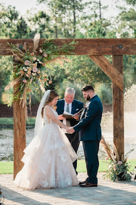 bride and groom standing at altar holding hands