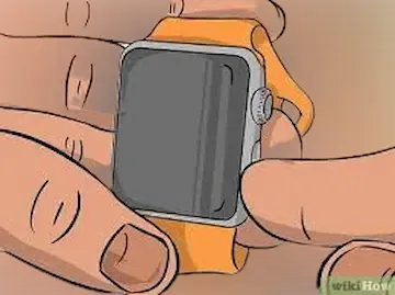 Hand holding Apple Watch and cleaning it