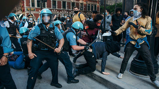 Photo of police rioting violently against people protesting the police murder of George Floyd.