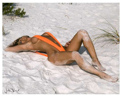A silver two piece sling bikini on a beach